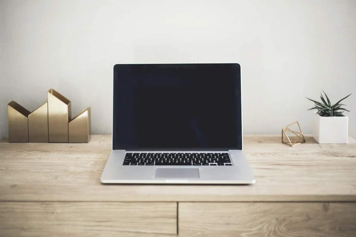 Laptop and everyday work essentials on a desk