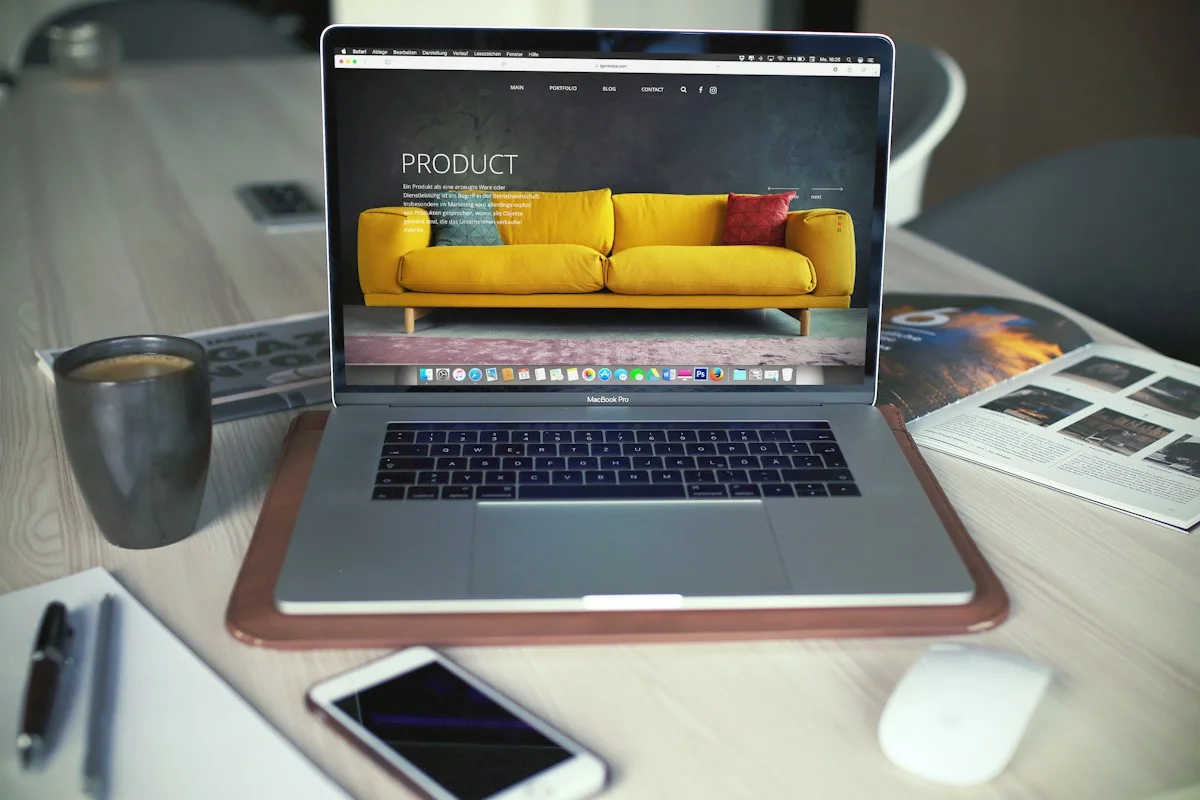 Laptop and phone beside a coffee cup